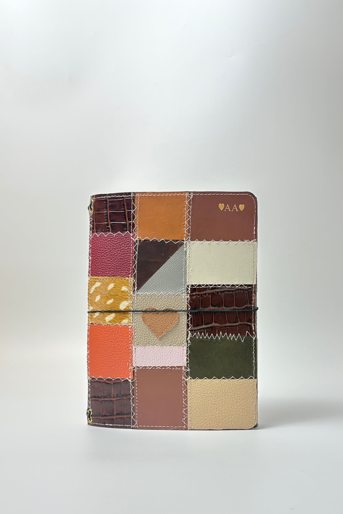 Patchwork-style notebook with multicolored squares on a white background