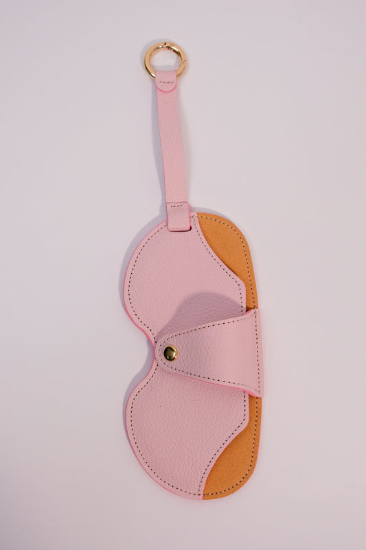 Pink and brown eye mask on a light pink background