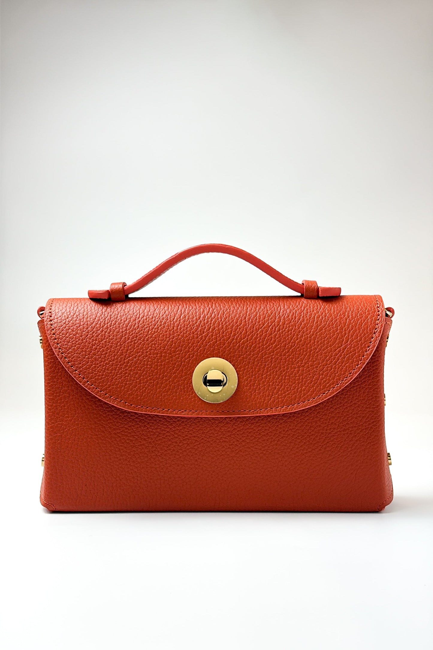 Orange handbag with a gold clasp on a white background