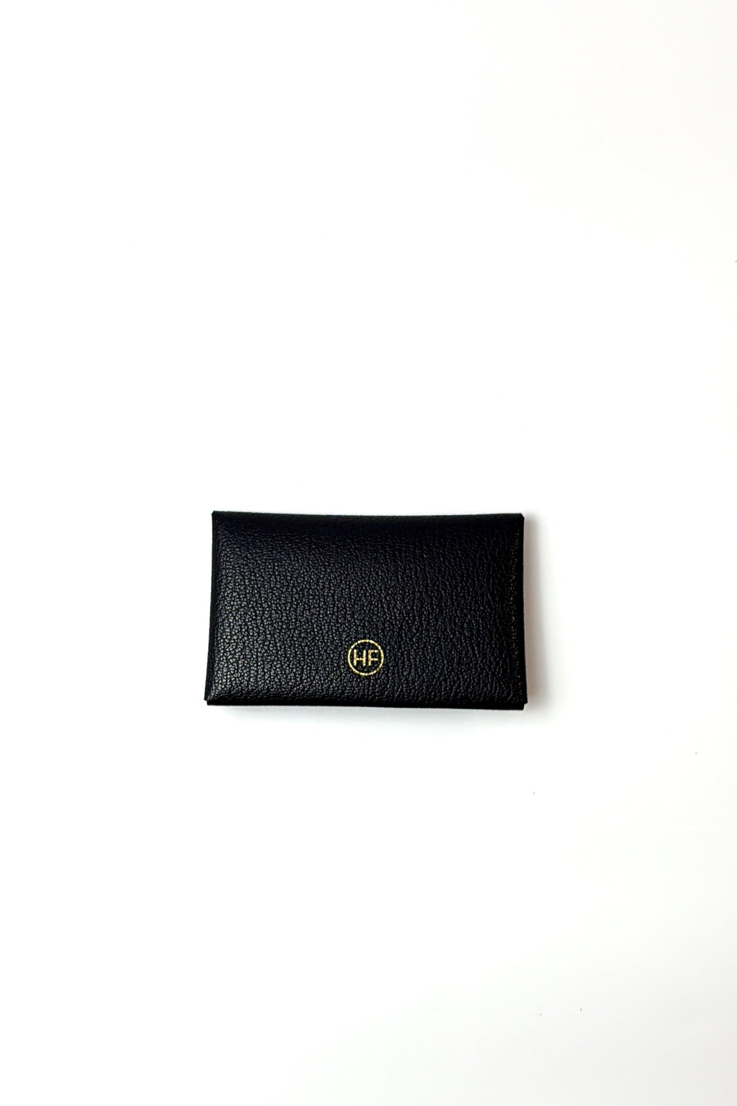 Black the plier leather cardholder with gold logo on a white background