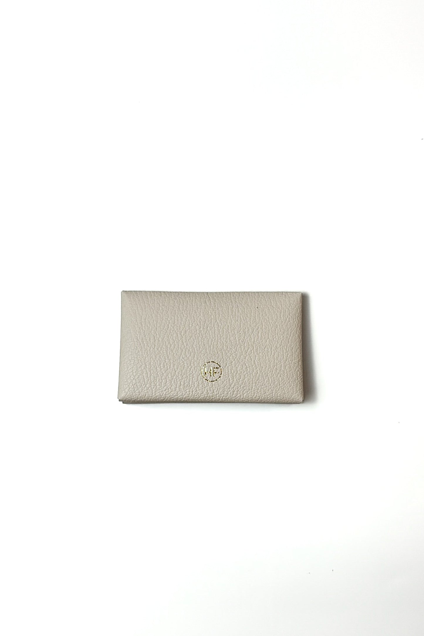 Beige wallet with a brand logo on a white background