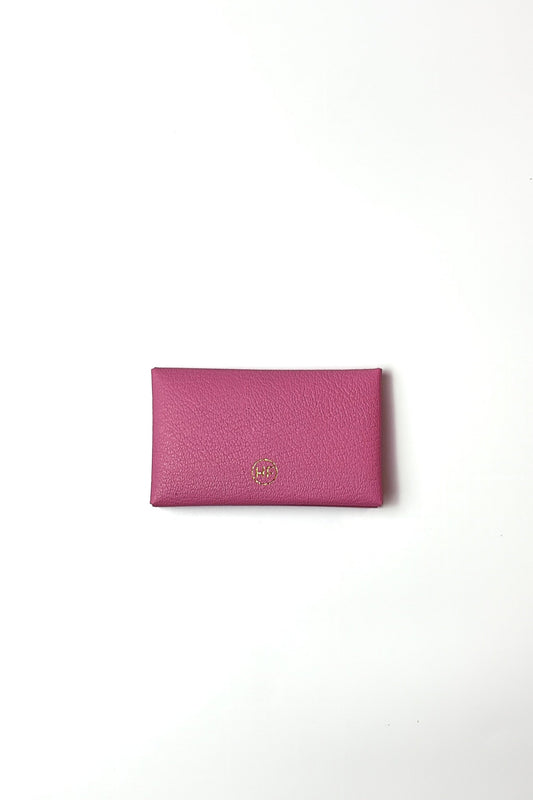 Pink wallet with a gold logo on a white background