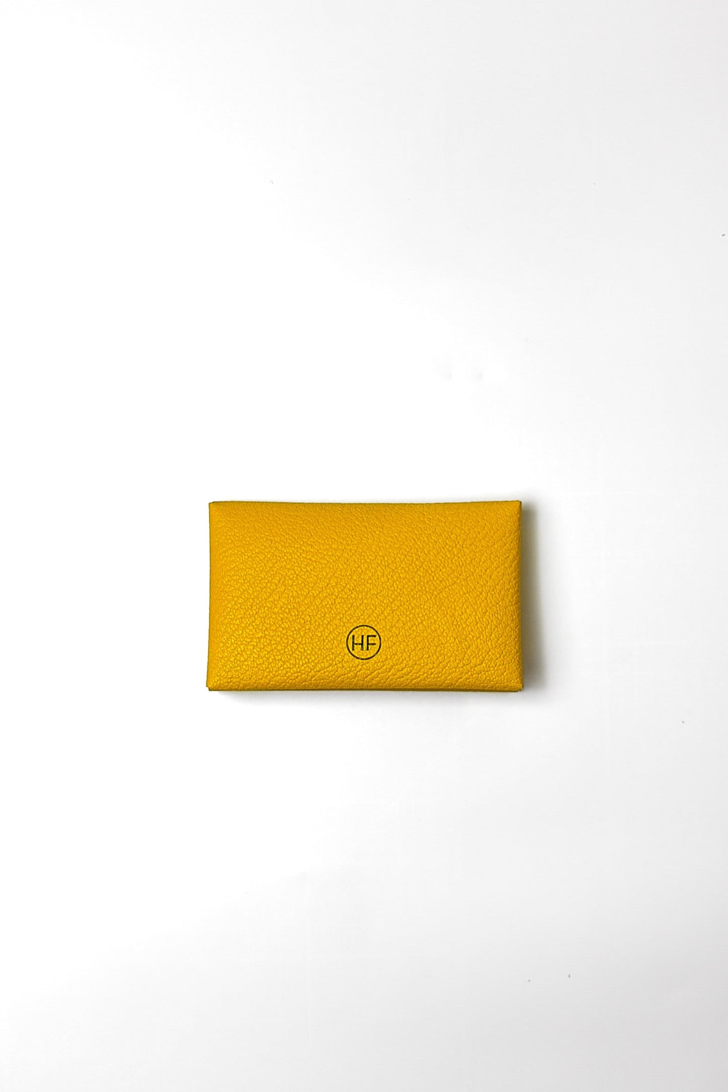 Yellow wallet with a brand logo on a white background