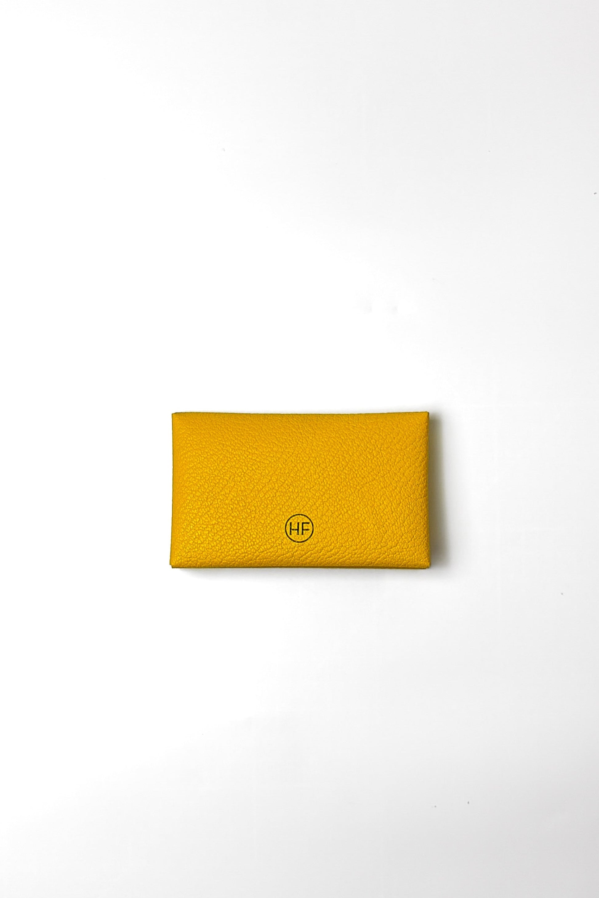 Yellow wallet with a brand logo on a white background