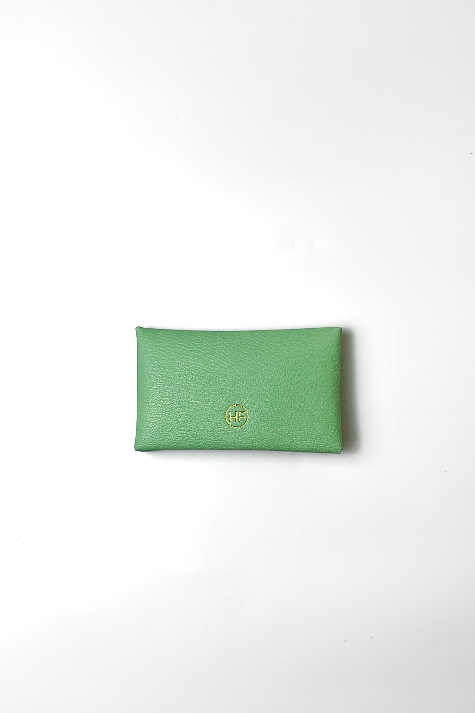 Green pouch with a brand logo on a white background