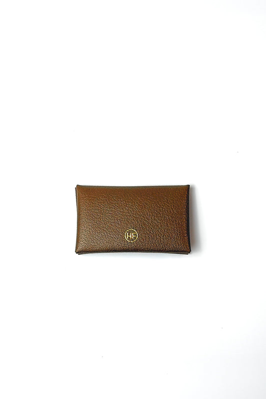 Brown leather wallet with a gold emblem on a white background